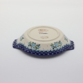 Round baking dish with handles made of Boleslawiec pottery.