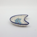Unique Bolesławiec tray in crescent shape, perfect for serving snacks.