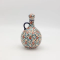 Hand-painted round decanter made from traditional Bolesławiec pottery. Unique ceramic bottle perfect for serving liqueurs, water, or as a table decoration.