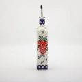 Combine traditional Polish craftsmanship with modern kitchen utility using this square Bolesławiec ceramic oil bottle.