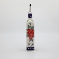 Combine traditional Polish craftsmanship with modern kitchen utility using this square Bolesławiec ceramic oil bottle.