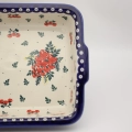 Bake and serve delicious home-cooked meals with this authentic Bolesławiec ceramic baking dish with side handles.