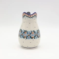Handmade Bolesławiec ceramic pitcher featuring traditional Polish pottery stamp patterns.
