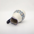 Handmade Bolesławiec ceramic pitcher featuring traditional Polish pottery stamp patterns.