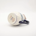 Handmade Bolesławiec ceramic pitcher featuring traditional Polish pottery stamp patterns.