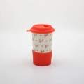 Handmade Bolesławiec ceramic travel mug with silicone lid featuring traditional Polish pottery patterns.