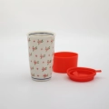 Handmade Bolesławiec ceramic travel mug with silicone lid featuring traditional Polish pottery patterns.