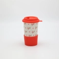 Handmade Bolesławiec ceramic travel mug with silicone lid featuring traditional Polish pottery patterns.