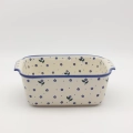 Handcrafted Bolesławiec ceramic baking dish with handles.