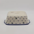 Handcrafted Bolesławiec ceramic baking dish with handles.