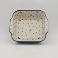 Handcrafted Bolesławiec ceramic baking dish with handles.