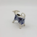 Traditional Bolesławiec stoneware creamer with an ergonomic handle and pour spout.