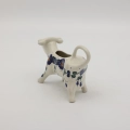 Traditional Bolesławiec stoneware creamer with an ergonomic handle and pour spout.