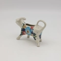 Traditional Bolesławiec stoneware creamer with an ergonomic handle and pour spout.