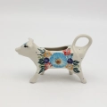 Traditional Bolesławiec stoneware creamer with an ergonomic handle and pour spout.