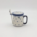 Handcrafted Bolesławiec ceramic tea mug with infuser and lid, traditional hand-painted pattern.