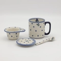 Handcrafted Bolesławiec ceramic tea mug with infuser and lid, traditional hand-painted pattern.