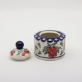 Elegant ceramic sugar dish with convenient lid and detailed hand-stamped decoration.