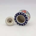 Elegant ceramic sugar dish with convenient lid and detailed hand-stamped decoration.