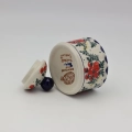 Elegant ceramic sugar dish with convenient lid and detailed hand-stamped decoration.