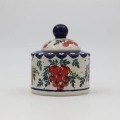 Elegant ceramic sugar dish with convenient lid and detailed hand-stamped decoration.