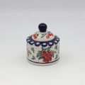 Elegant ceramic sugar dish with convenient lid and detailed hand-stamped decoration.