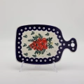 Small ceramic cheese board with convenient handle for serving snacks and appetizers.