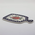 Small ceramic cheese board with convenient handle for serving snacks and appetizers.
