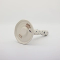 Ceramic paper towel holder featuring a vibrant hand-painted pattern.