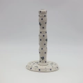 Ceramic paper towel holder featuring a vibrant hand-painted pattern.