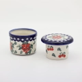 Hand-decorated ceramic water butter crock combining traditional utility with table elegance.