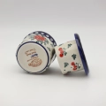Hand-decorated ceramic water butter crock combining traditional utility with table elegance.