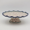Decorative stoneware cake server showcasing classic Polish pottery craftsmanship.