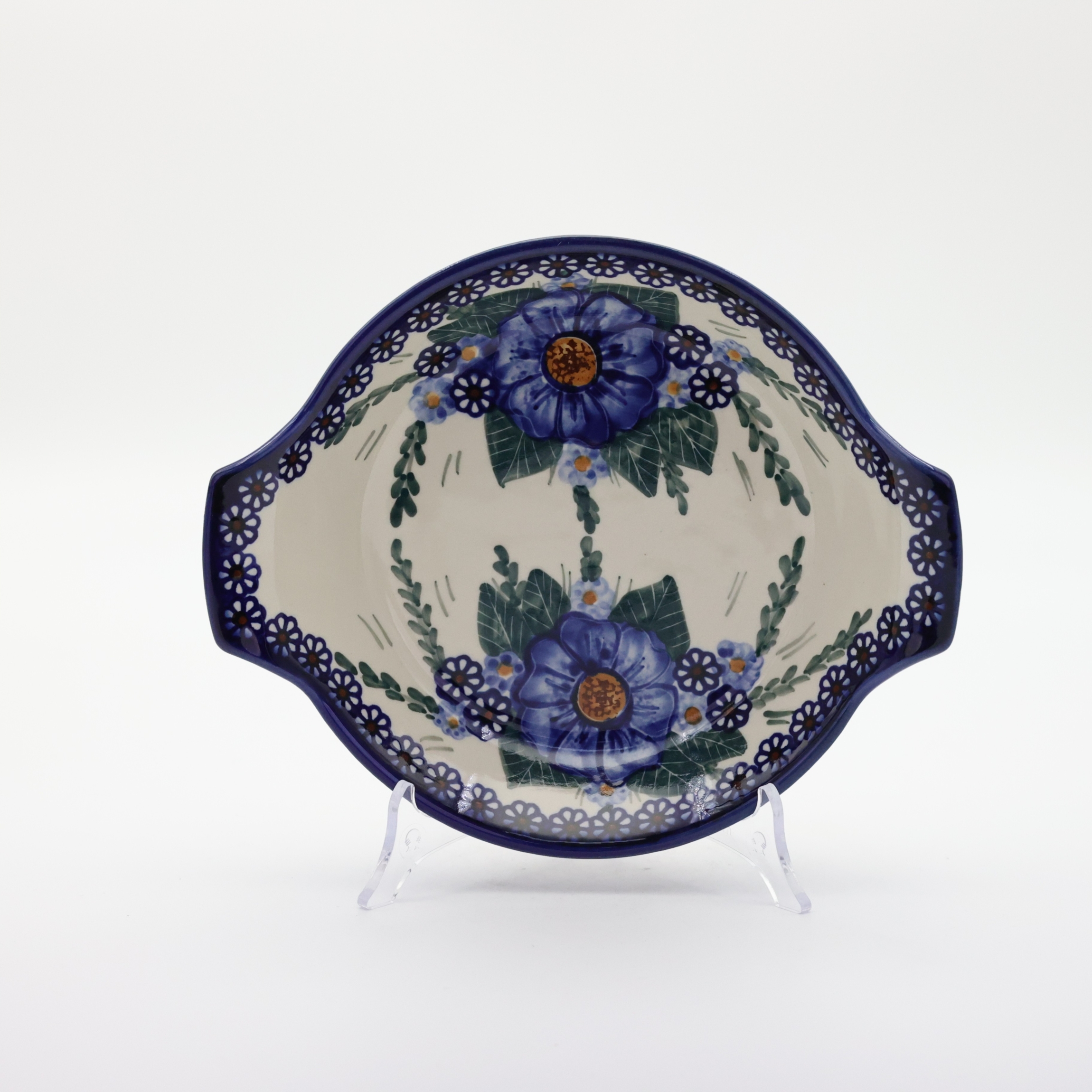 Round baking dish with handles made of Boleslawiec pottery.