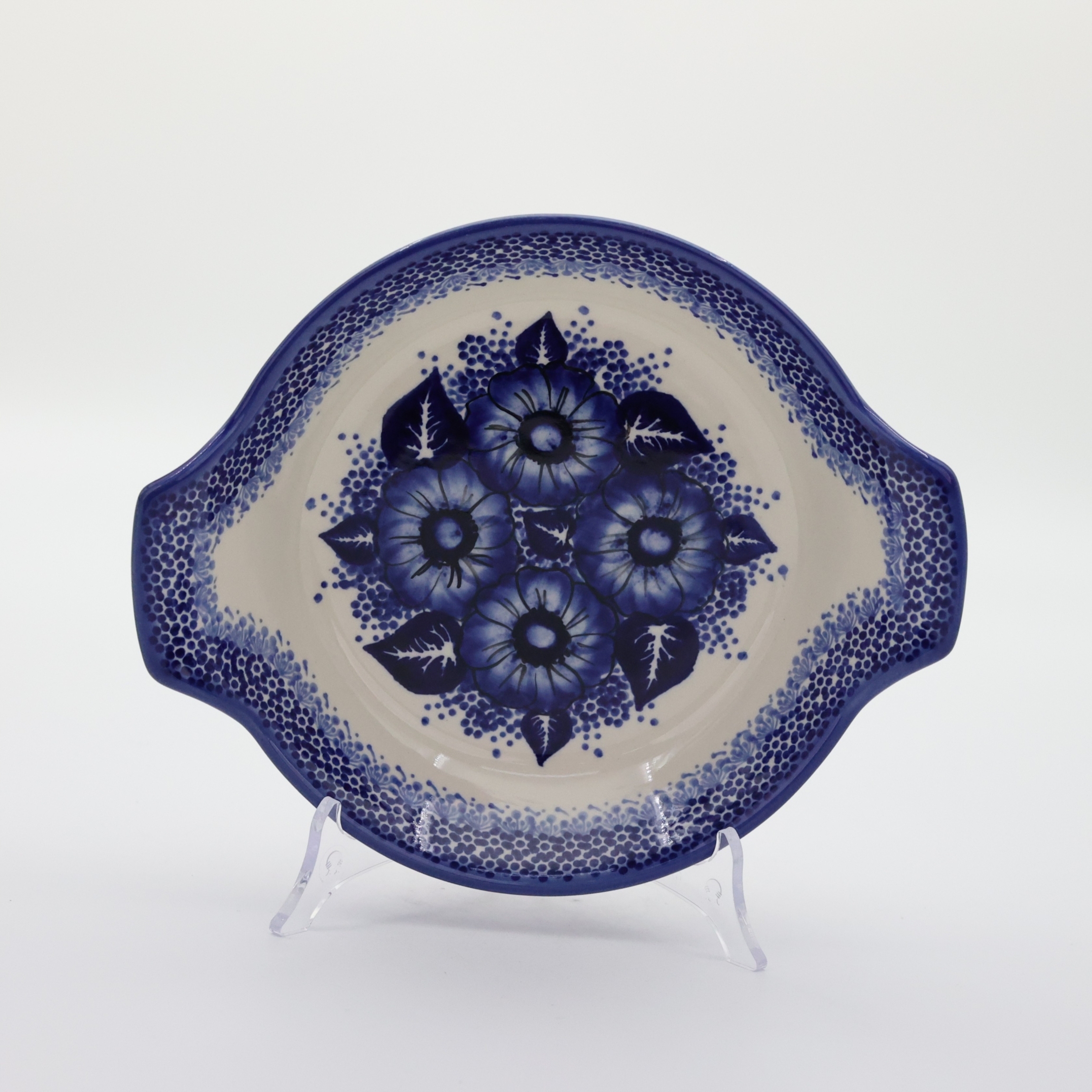 Hand decorated round baking dish with handles made from authentic Boleslawiec pottery.