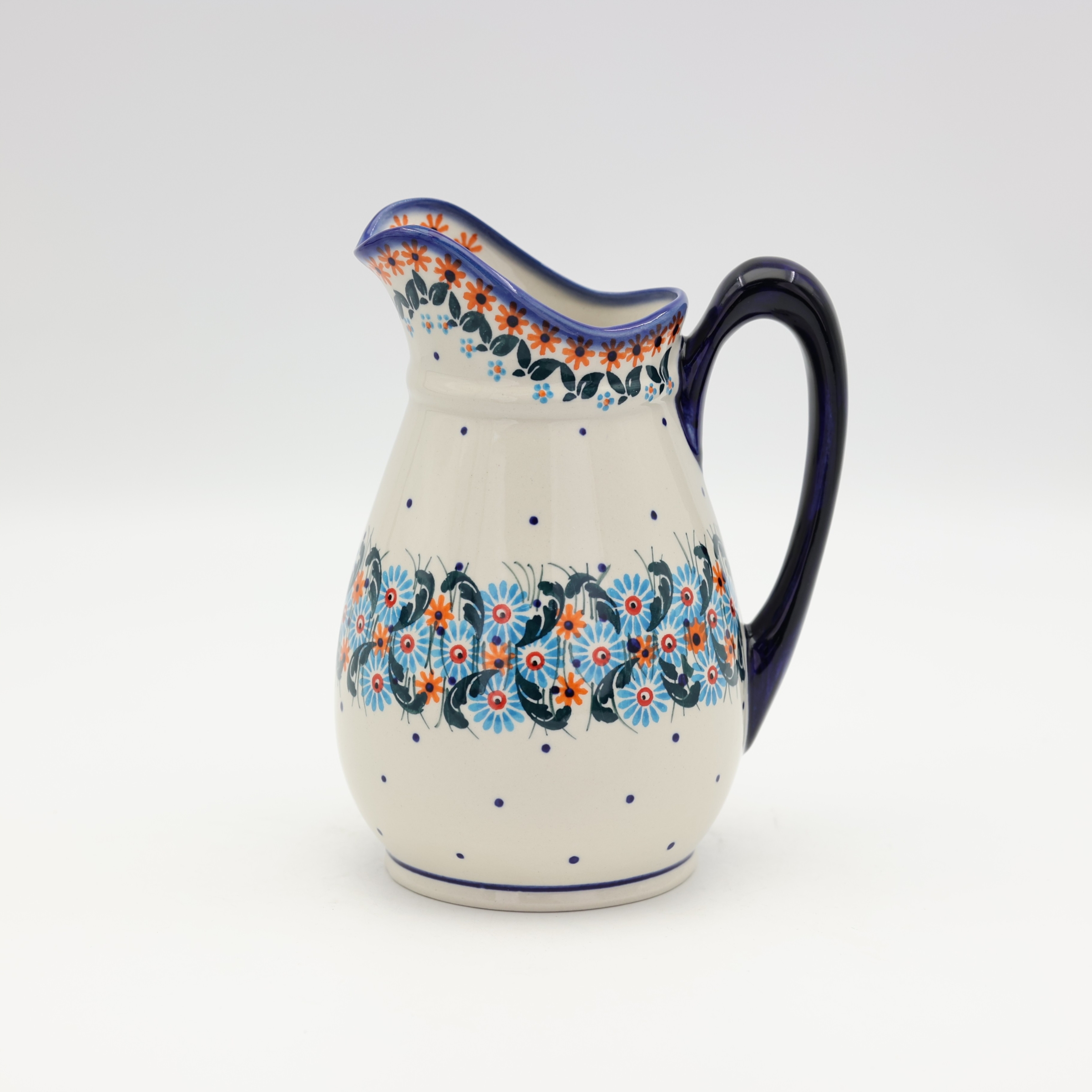 Handmade Bolesławiec ceramic pitcher featuring traditional Polish pottery stamp patterns.