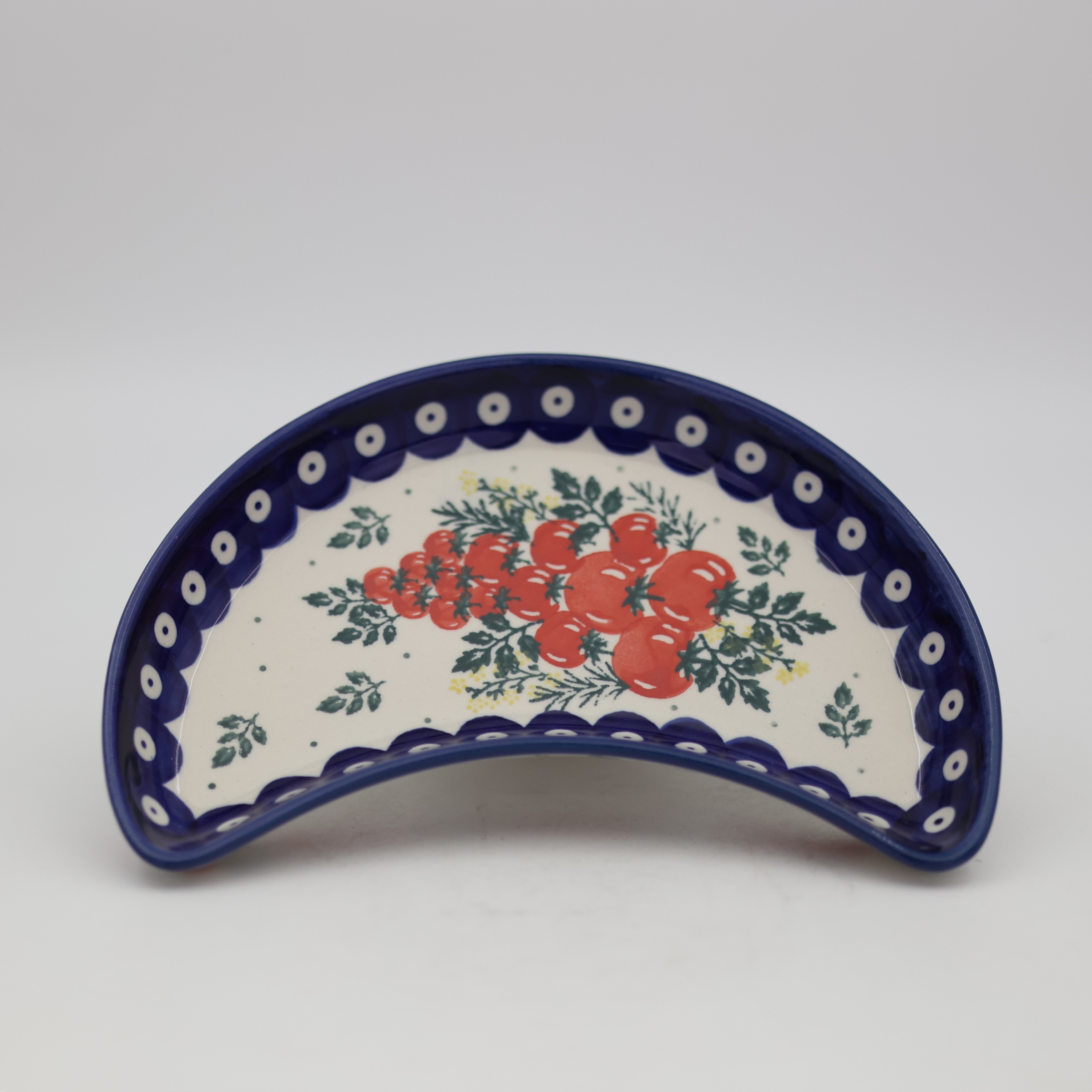 Handmade Bolesławiec ceramic crescent tray featuring traditional Polish pottery stamp patterns.