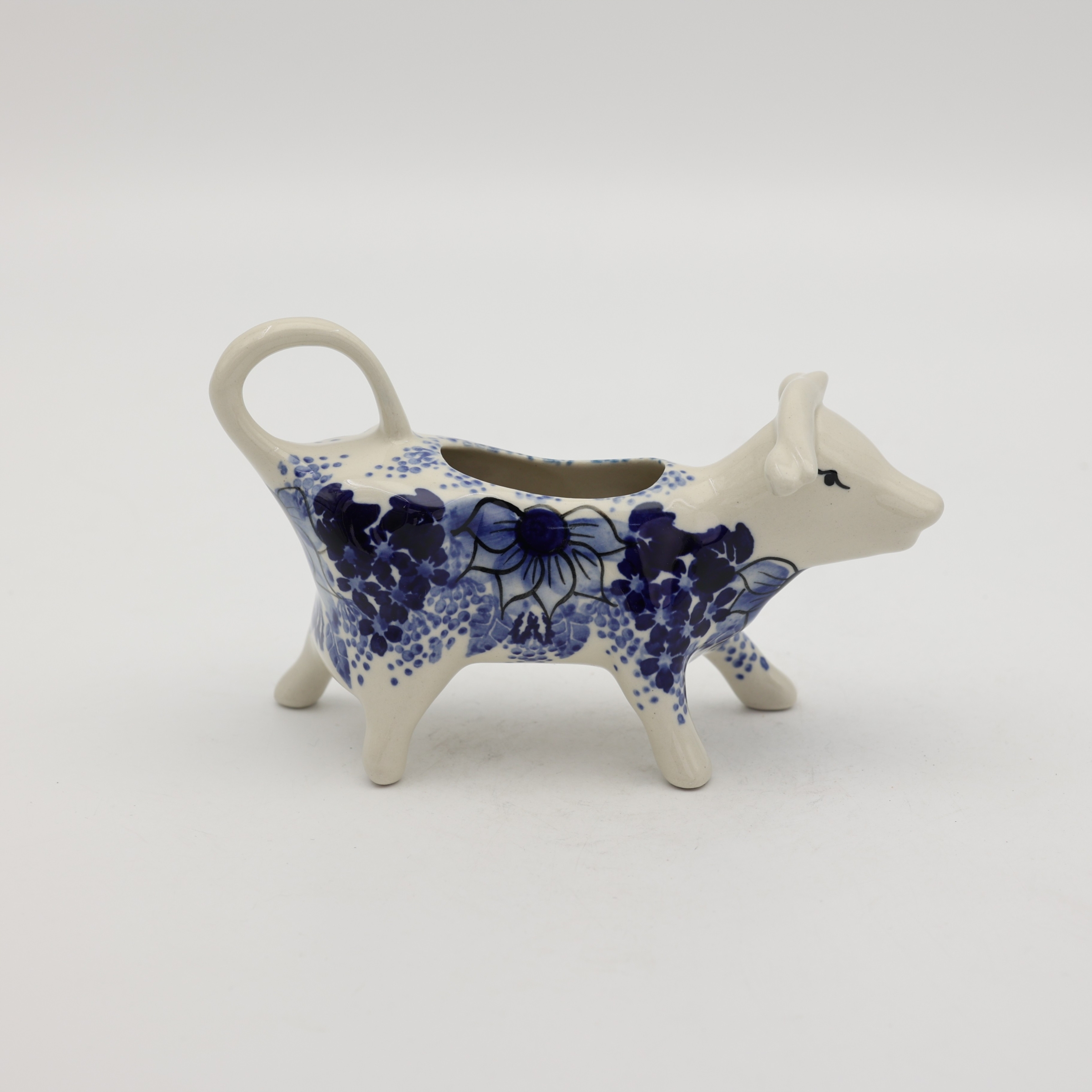 Traditional Bolesławiec stoneware creamer with an ergonomic handle and pour spout.