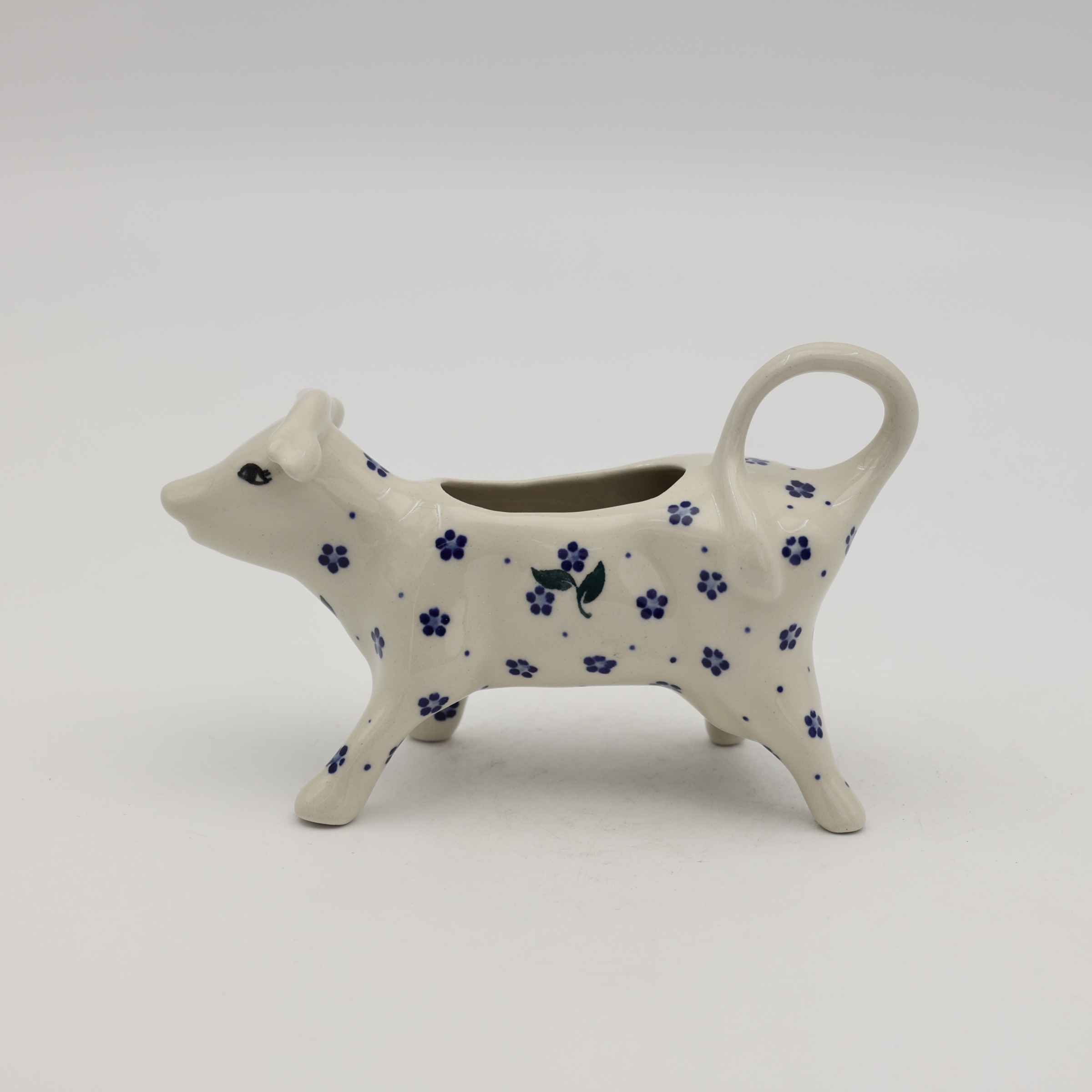 Traditional Bolesławiec stoneware creamer with an ergonomic handle and pour spout.