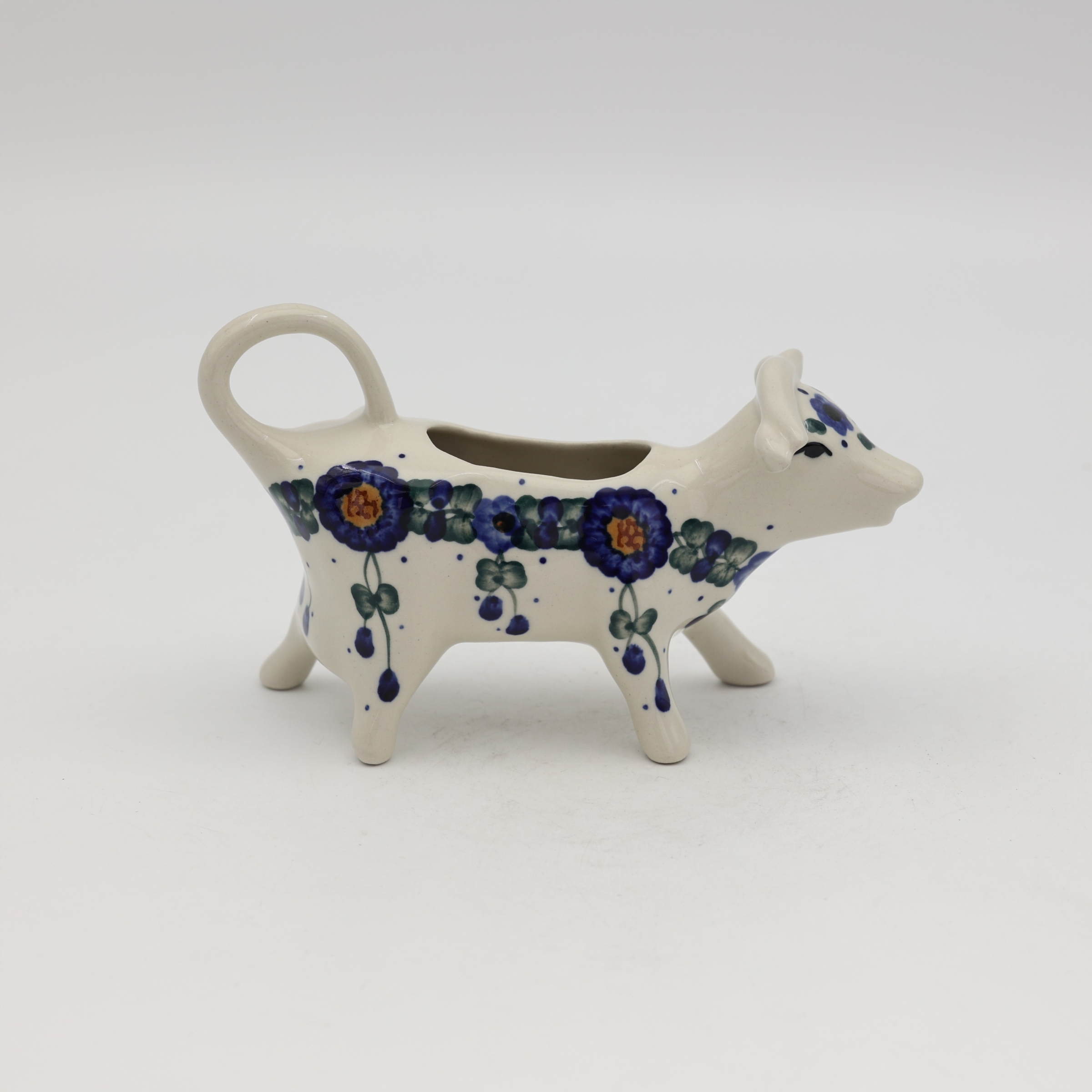 Traditional Bolesławiec stoneware creamer with an ergonomic handle and pour spout.