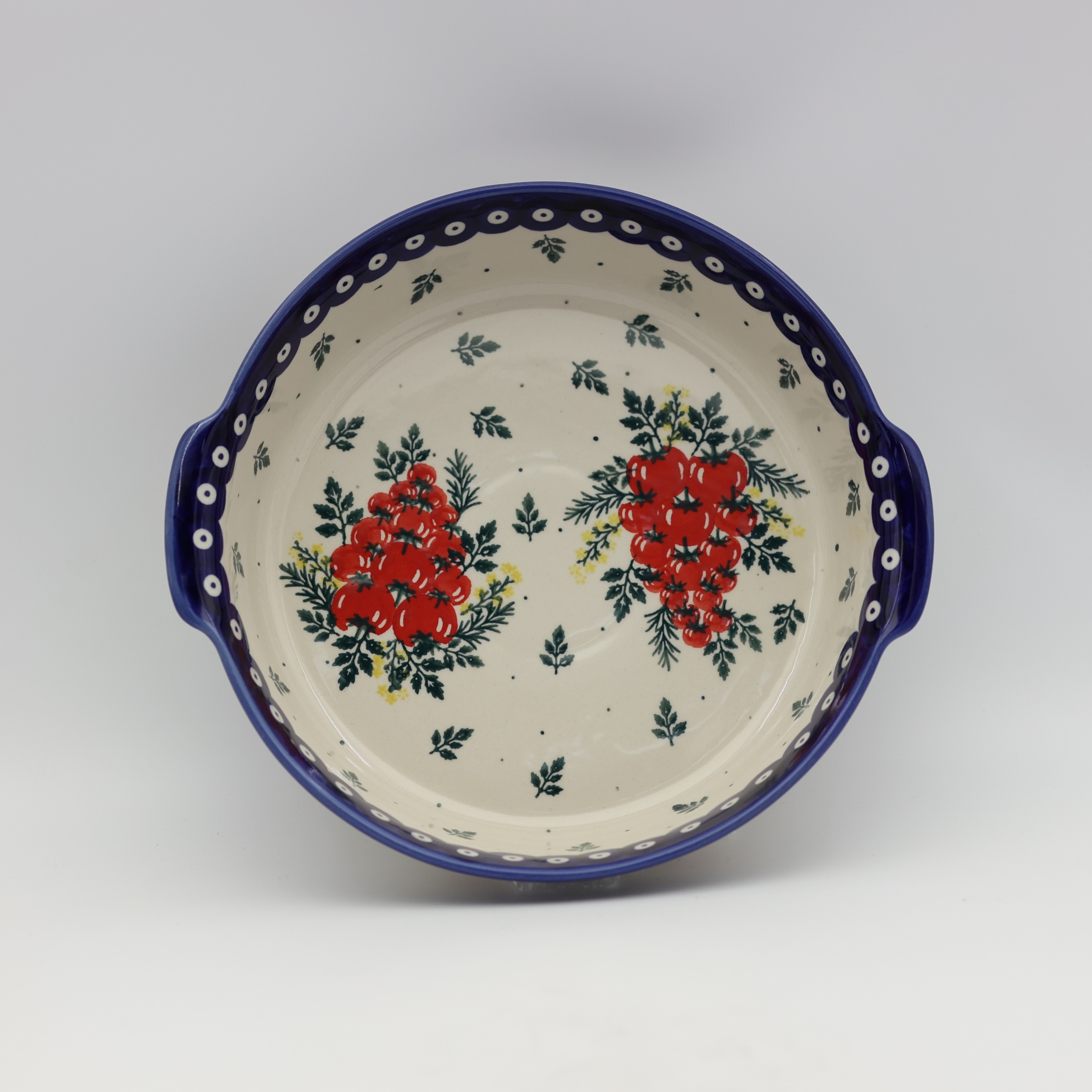 Round ceramic serving dish with handles, perfect for baked meals, snacks, and appetizers.