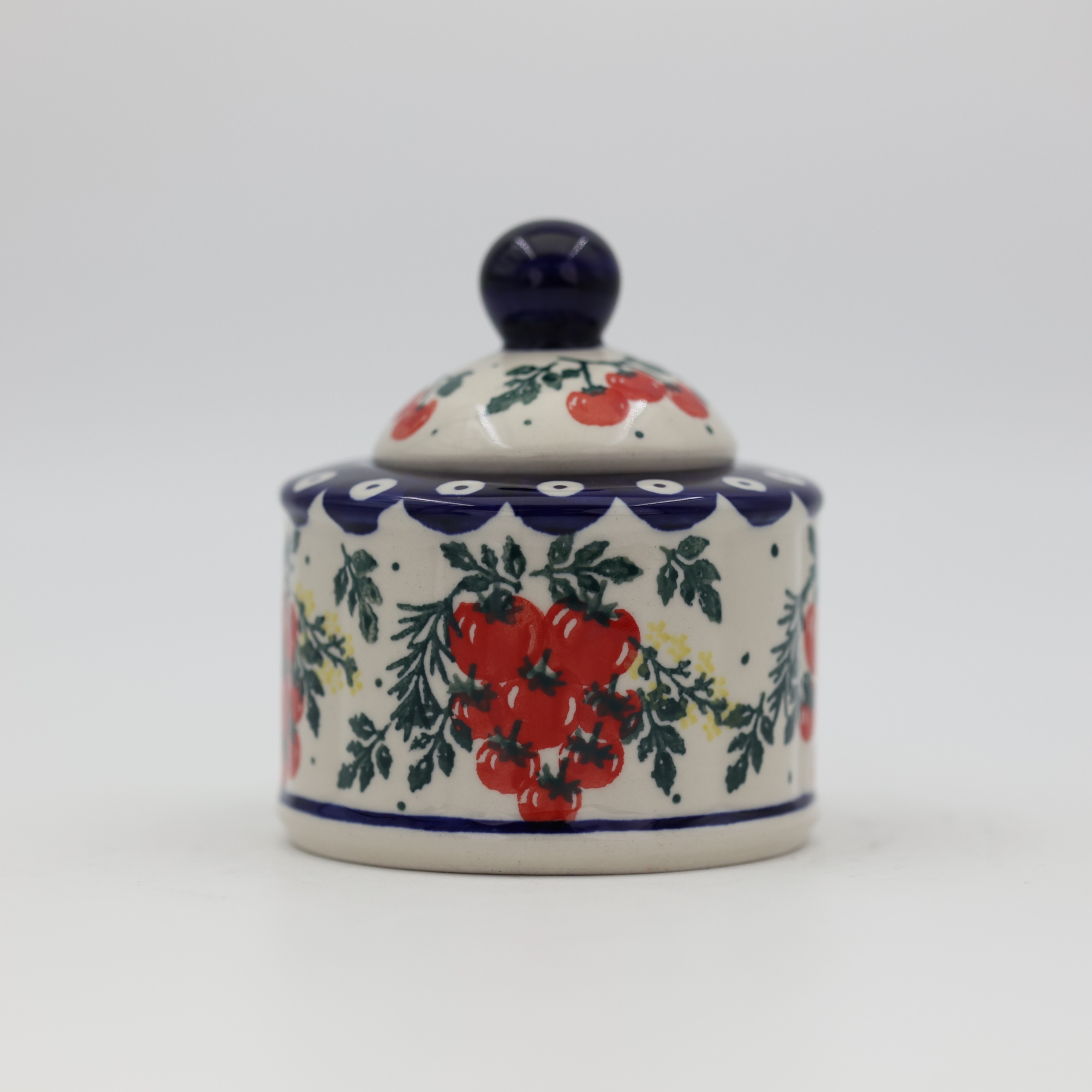 Elegant ceramic sugar dish with convenient lid and detailed hand-stamped decoration.