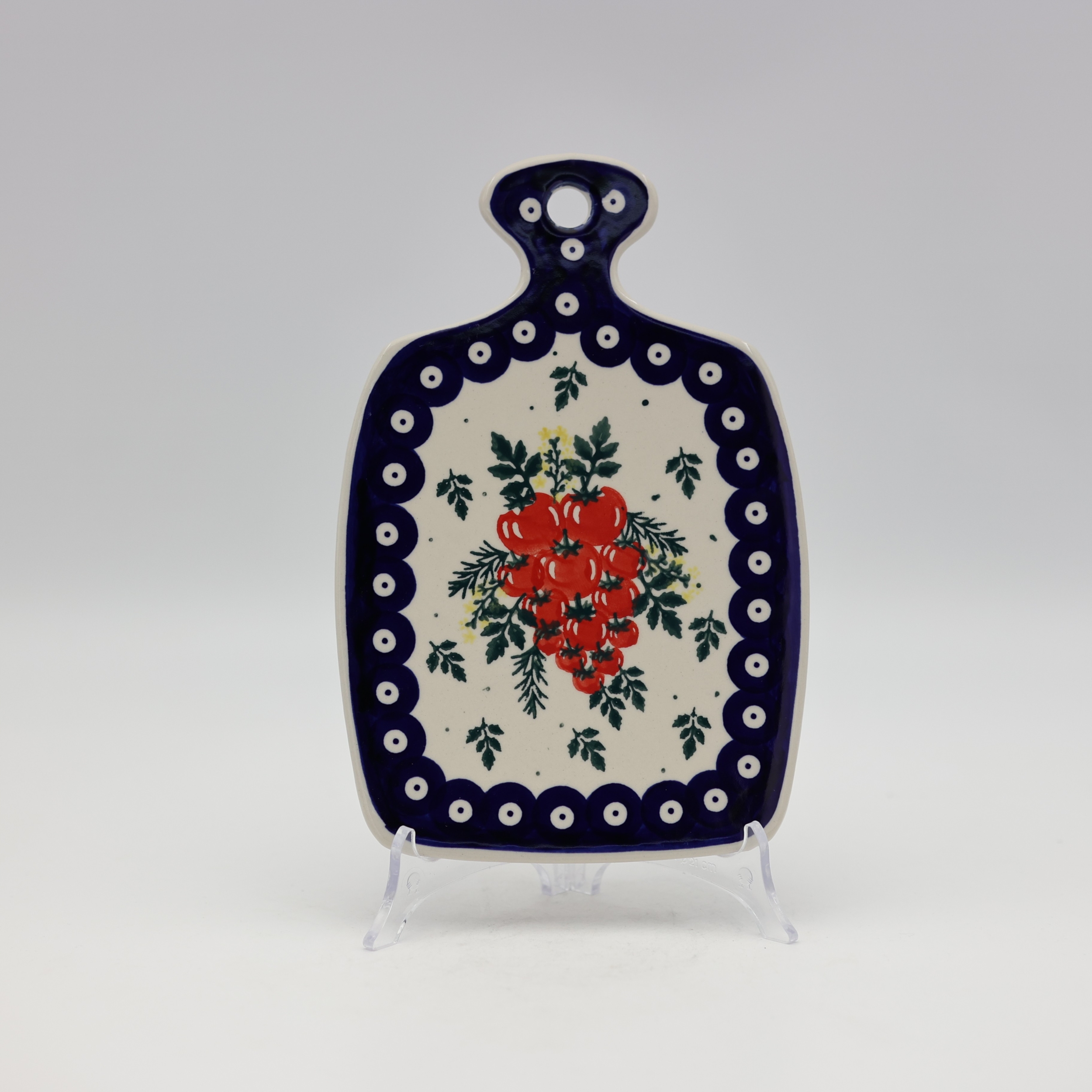 Small ceramic cheese board with convenient handle for serving snacks and appetizers.