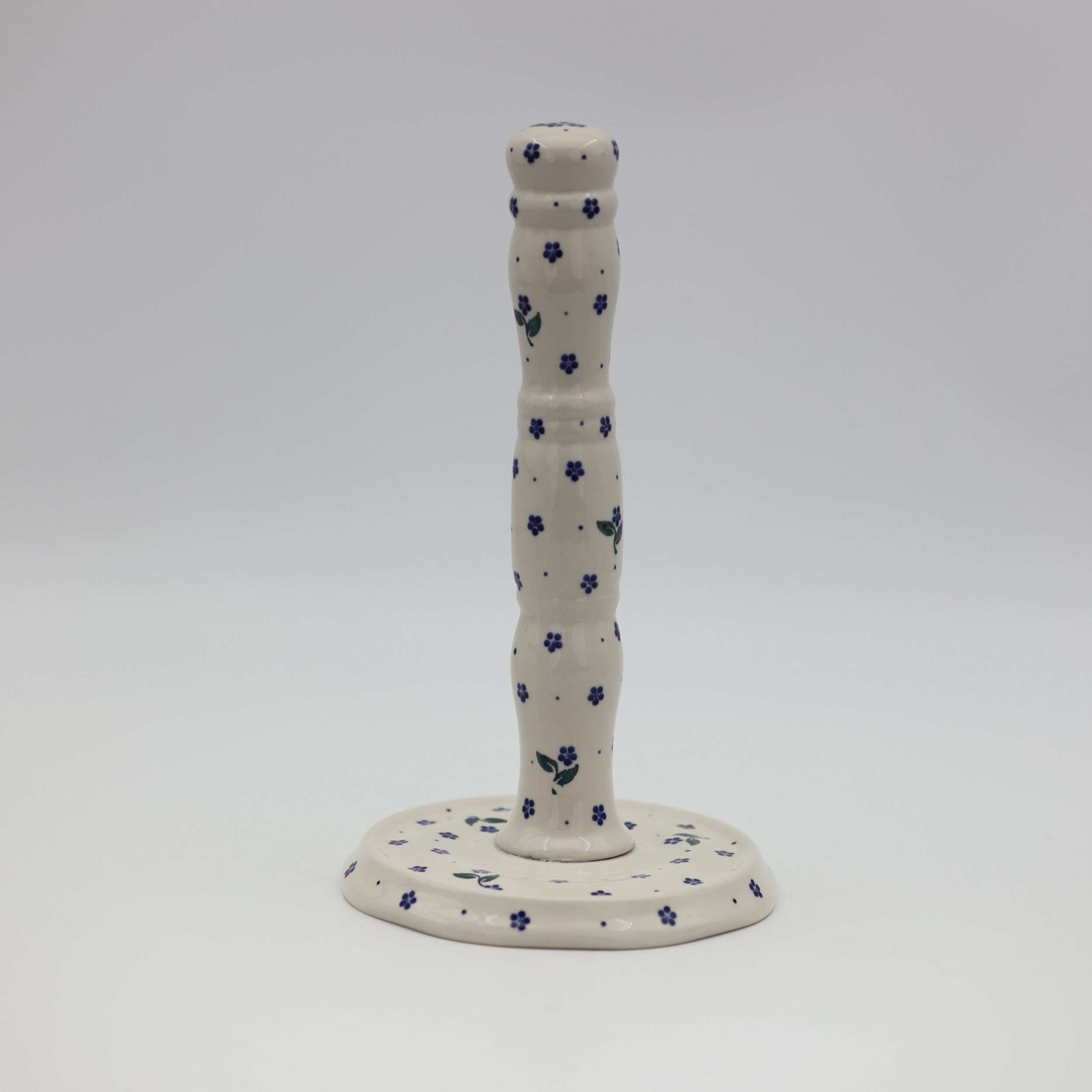 Ceramic paper towel holder featuring a vibrant hand-painted pattern.