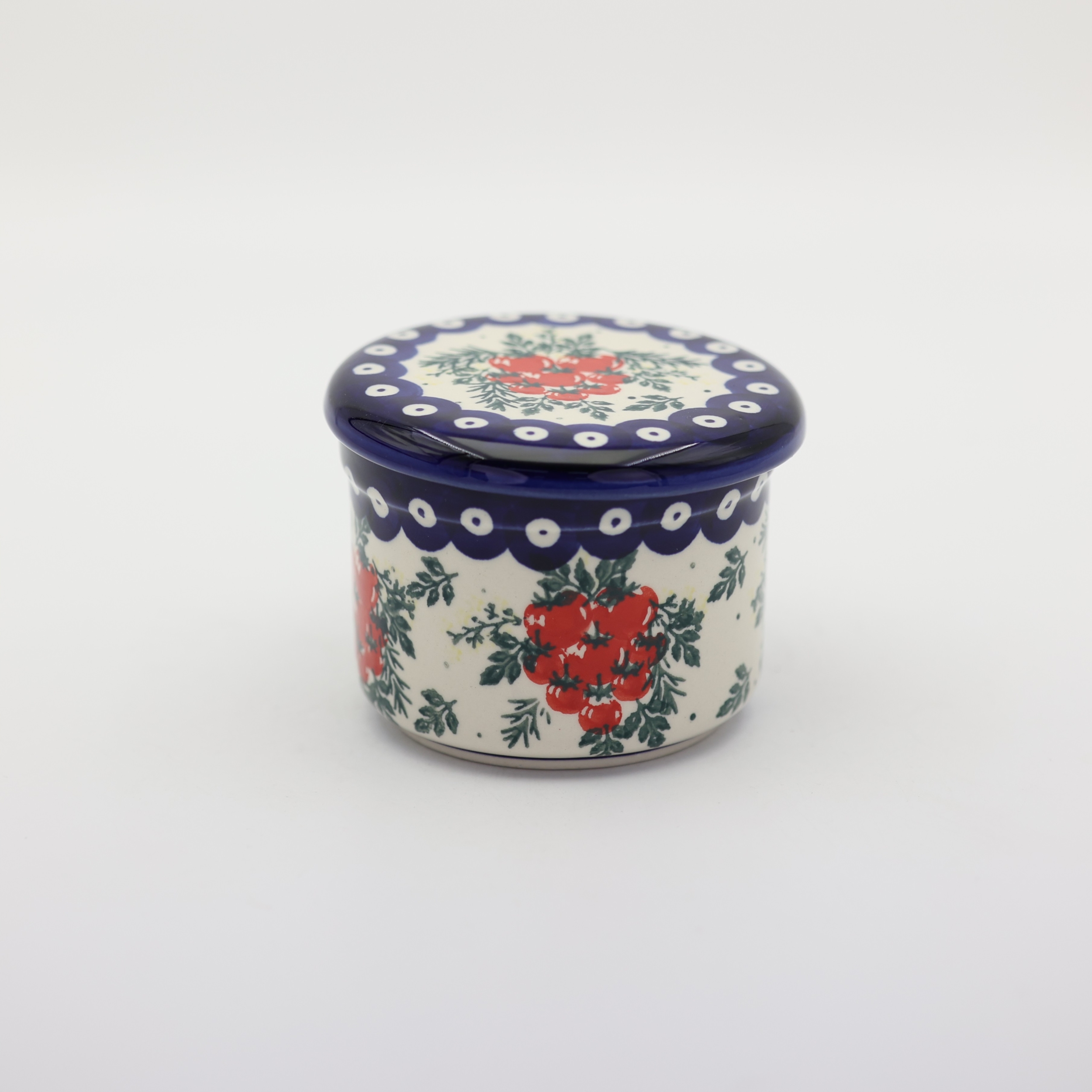 Hand-decorated ceramic water butter crock combining traditional utility with table elegance.